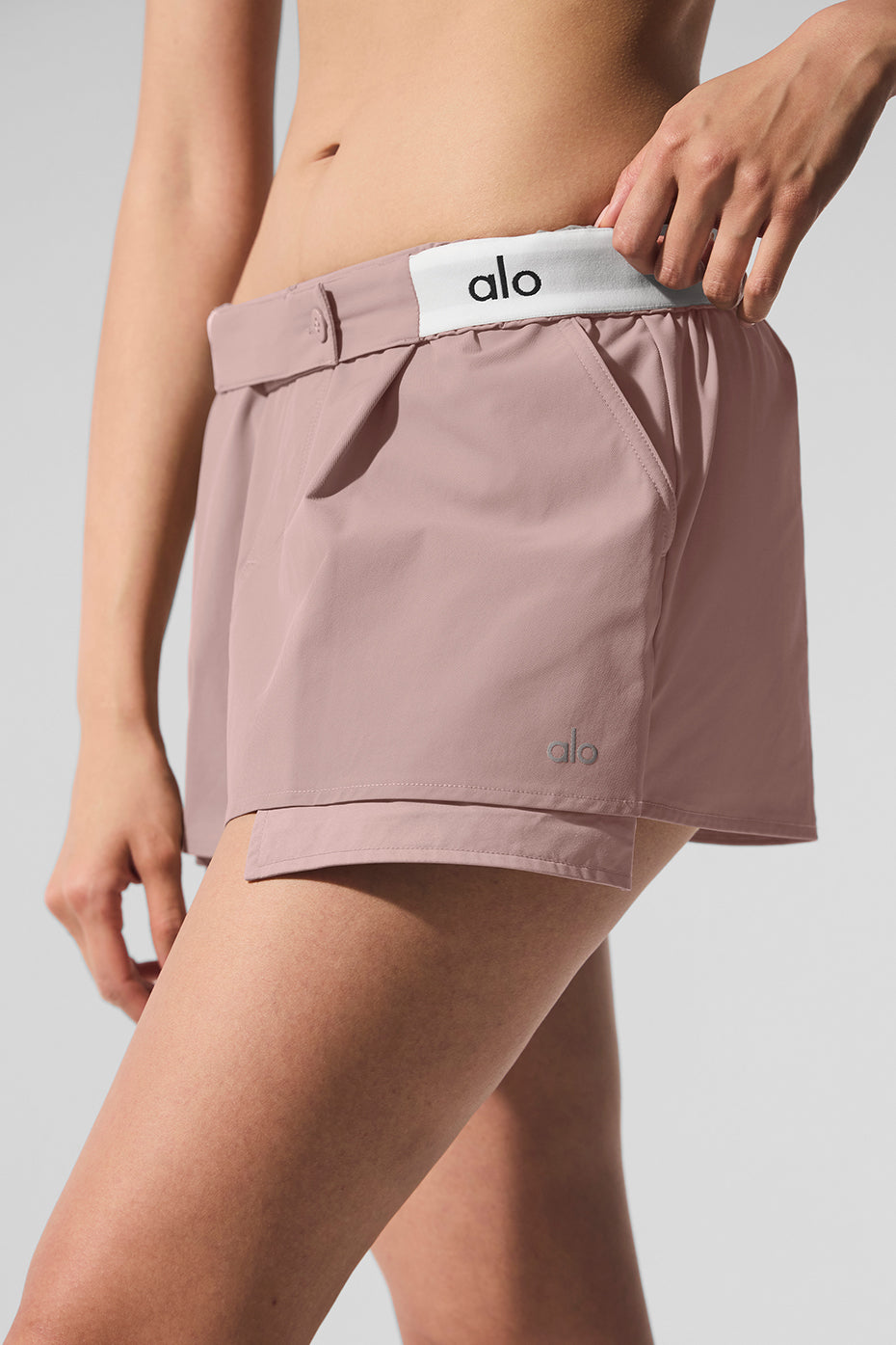Front view of taupe mini skort worn casually outdoors in Miami sun