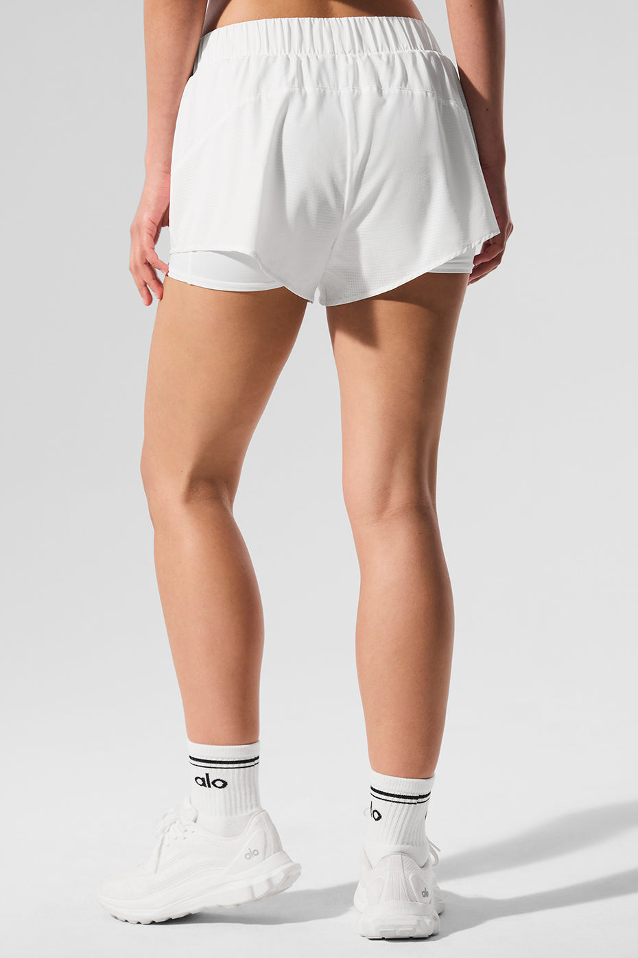 Front view of Sport Star White Running Shorts on a model during a jog.
