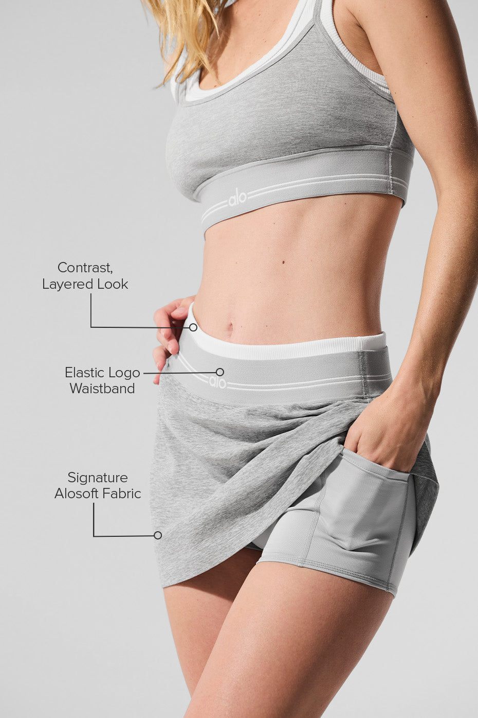 Model wearing the heather grey tennis skirt during a match.