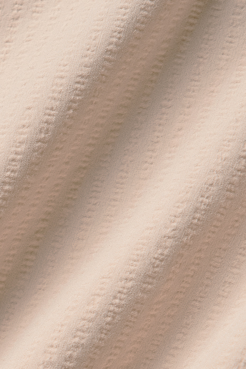 Front view of the Dreamscape pleated tennis skirt in Macadamia, showcasing its lightweight fabric.