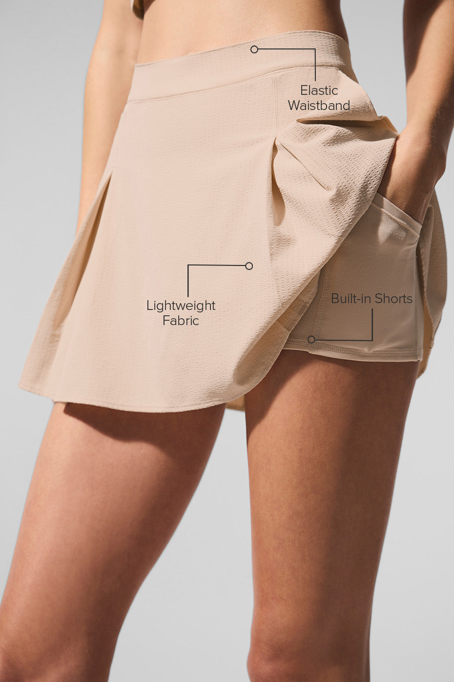 Side view of the Dreamscape tennis skirt, highlighting the pleated design and built-in shorts.