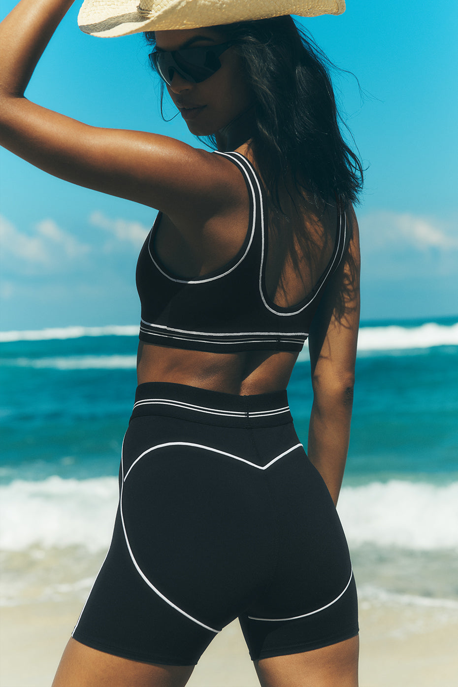 Front view of black and white high-waist workout shorts styled with matching bra.