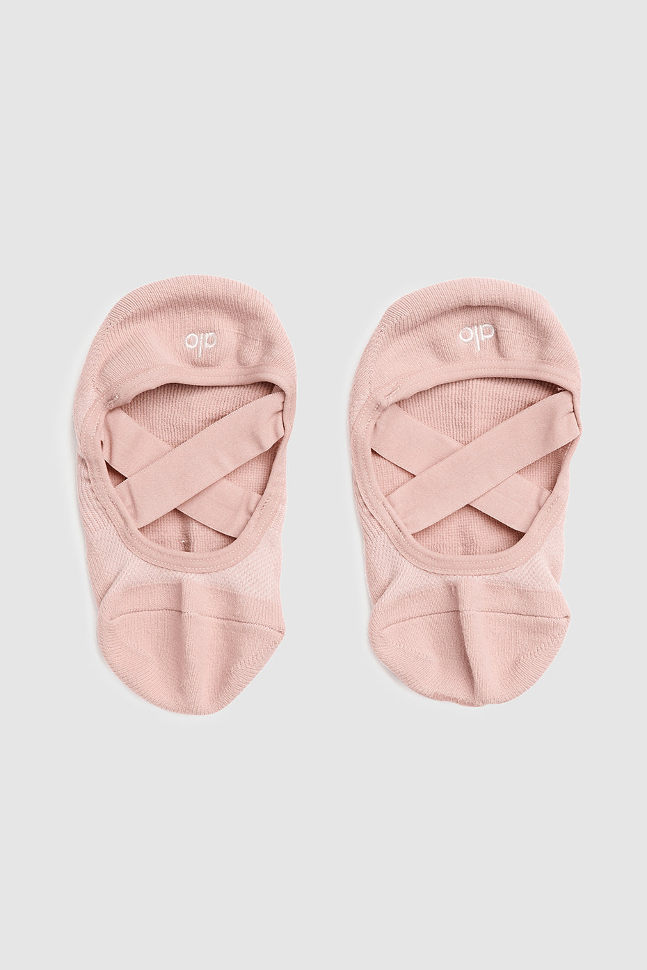 Studio fitness apparel featuring barre socks folded neatly with logo visible