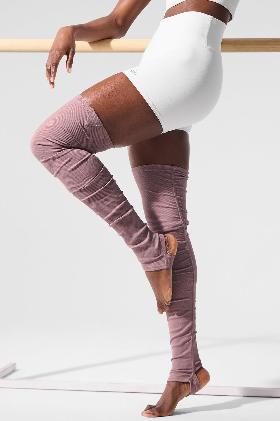 Ballet leg warmers styled over black leggings for dance rehearsal