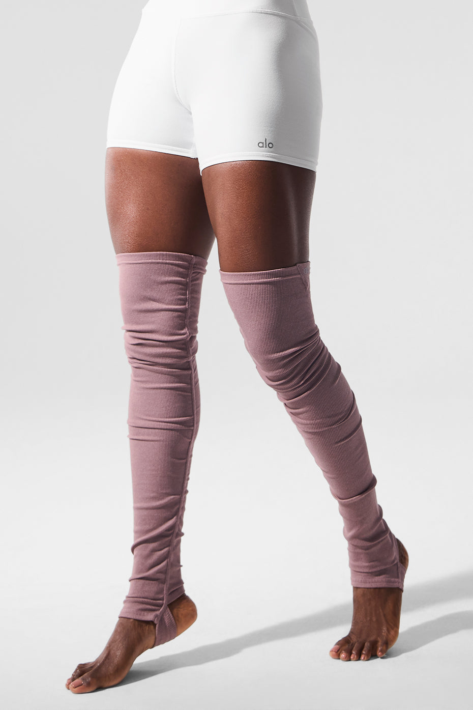 Leg warmers layered with activewear dress for transitional weather