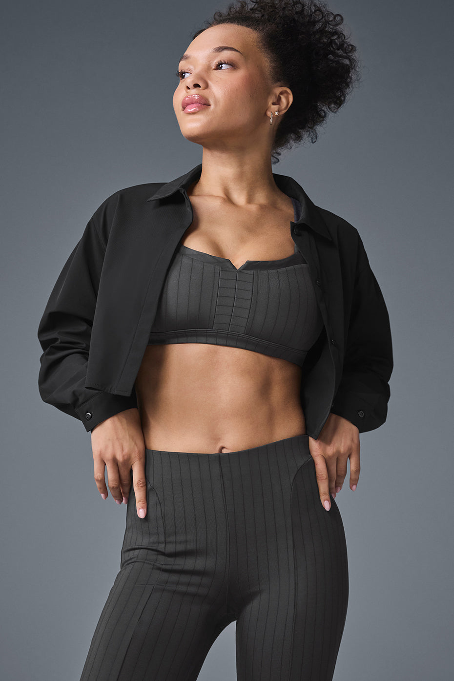 Front view of the chic cropped button-up shacket in black, styled with leggings.