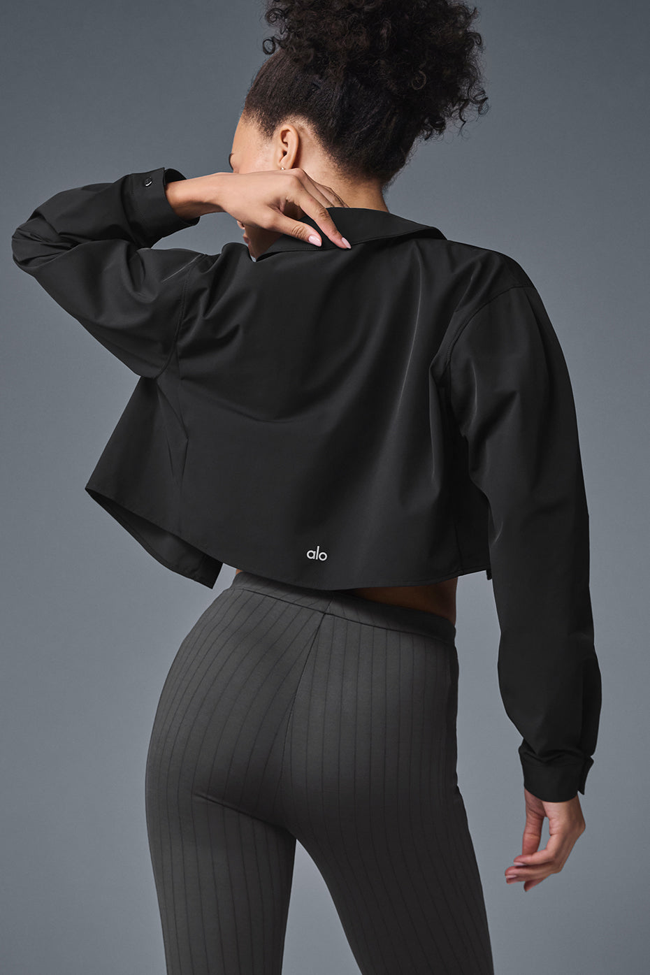 Close-up of the hidden buttons on the cropped shirt top, showcasing its sleek design.