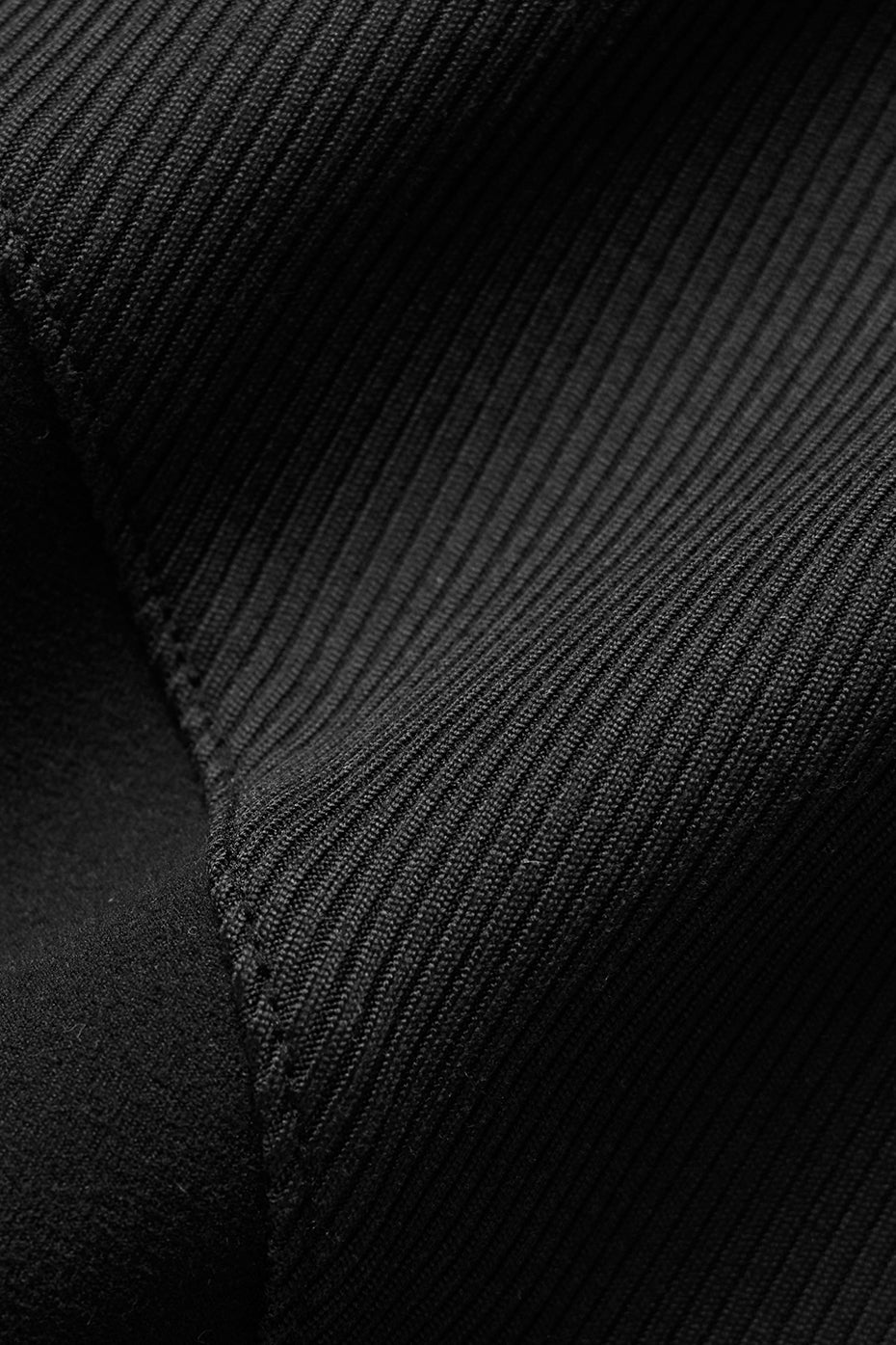Flat lay of black bodycon dress styled with heels and jacket for evening wear