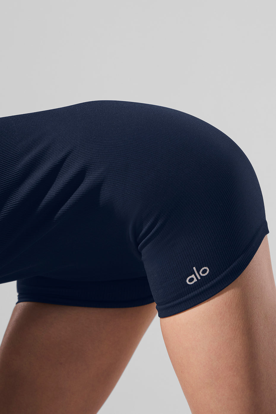Close-up of navy ribbed fabric on the onesie highlighting its smooth texture