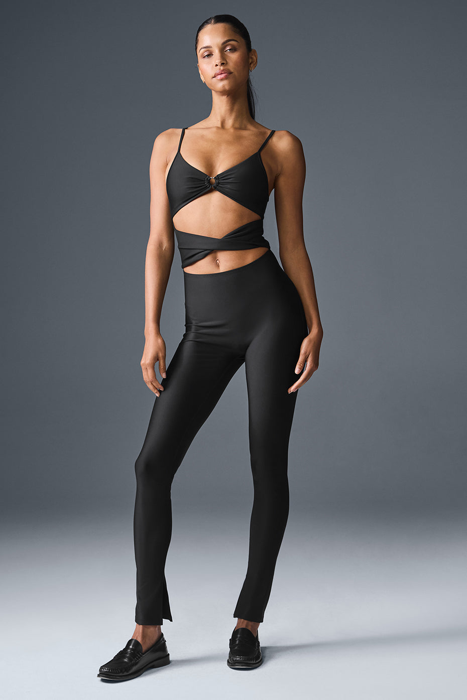 Front view of the Airlift A-List black jumpsuit showcasing cut-outs.