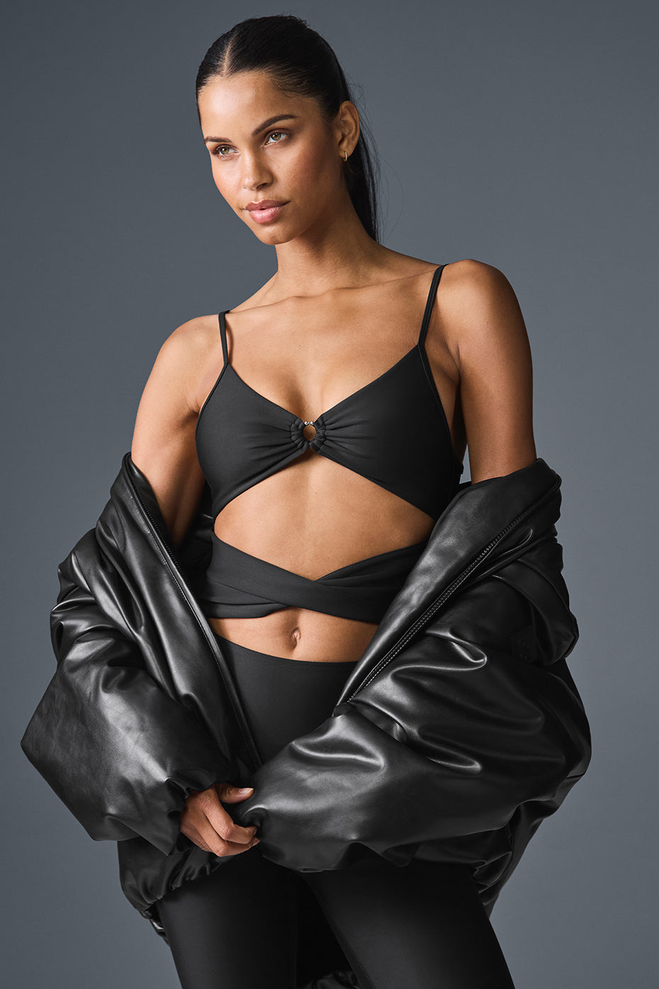 Front view of the Airlift A-List black jumpsuit showcasing cut-outs.