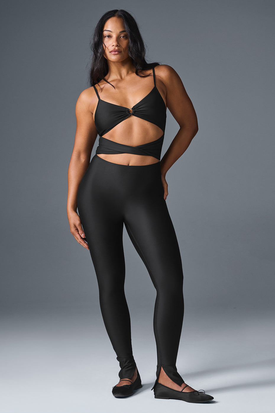 Side angle of the black jumpsuit highlighting the scooped back design.
