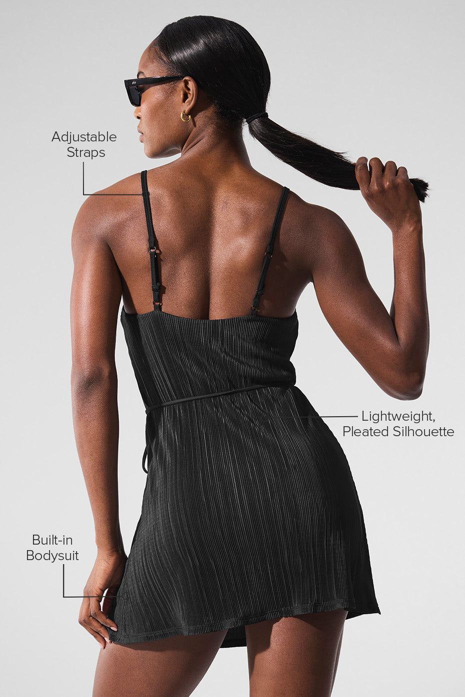 Side view of the black tennis dress highlighting the adjustable straps.
