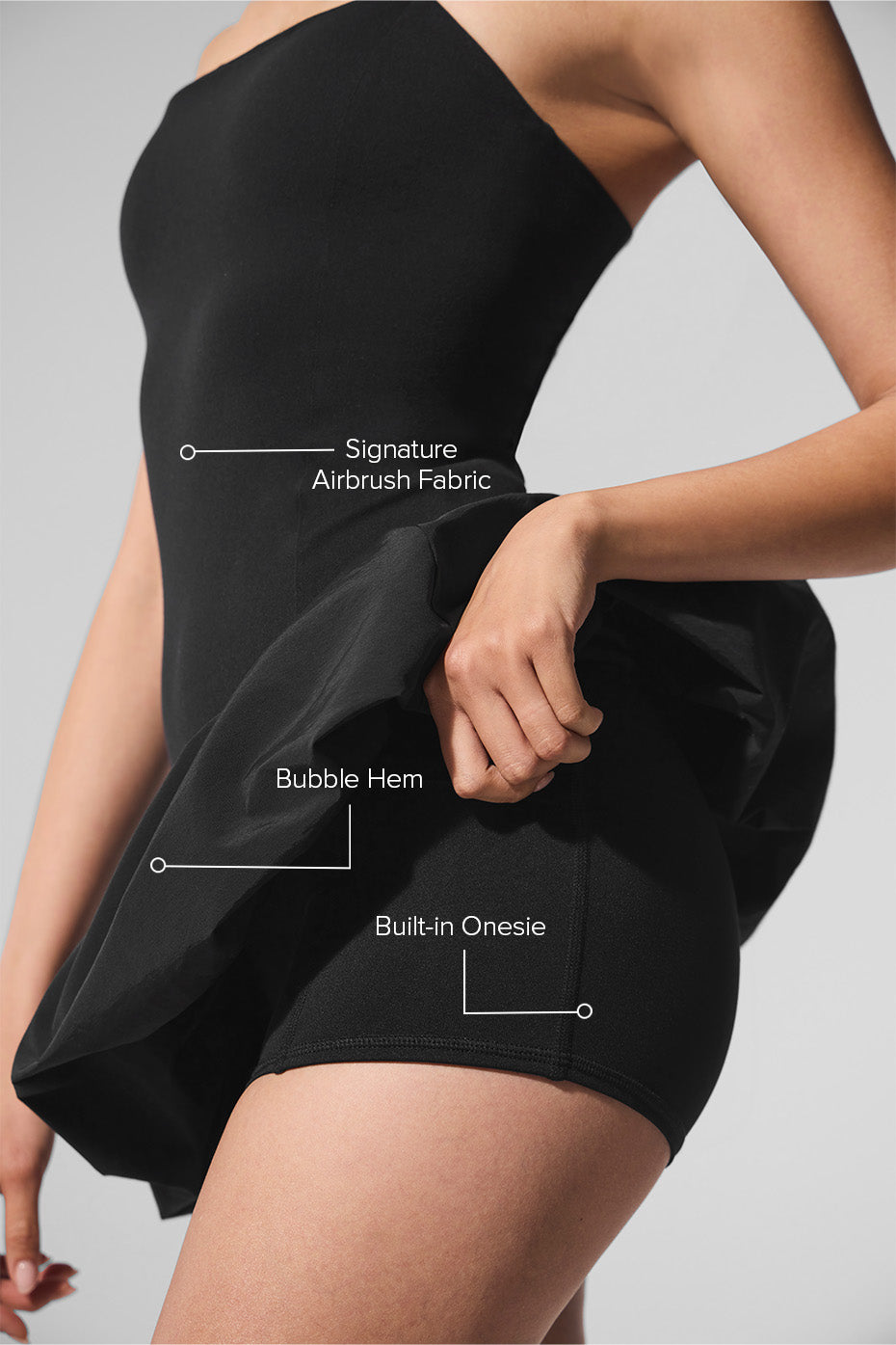 Side angle of the black performance tennis dress, highlighting its unique bubble hem.