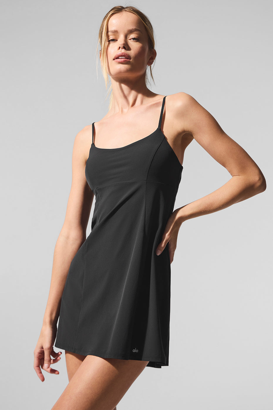 Wilson tennis dress on court, showcasing stretch fabric and movement.