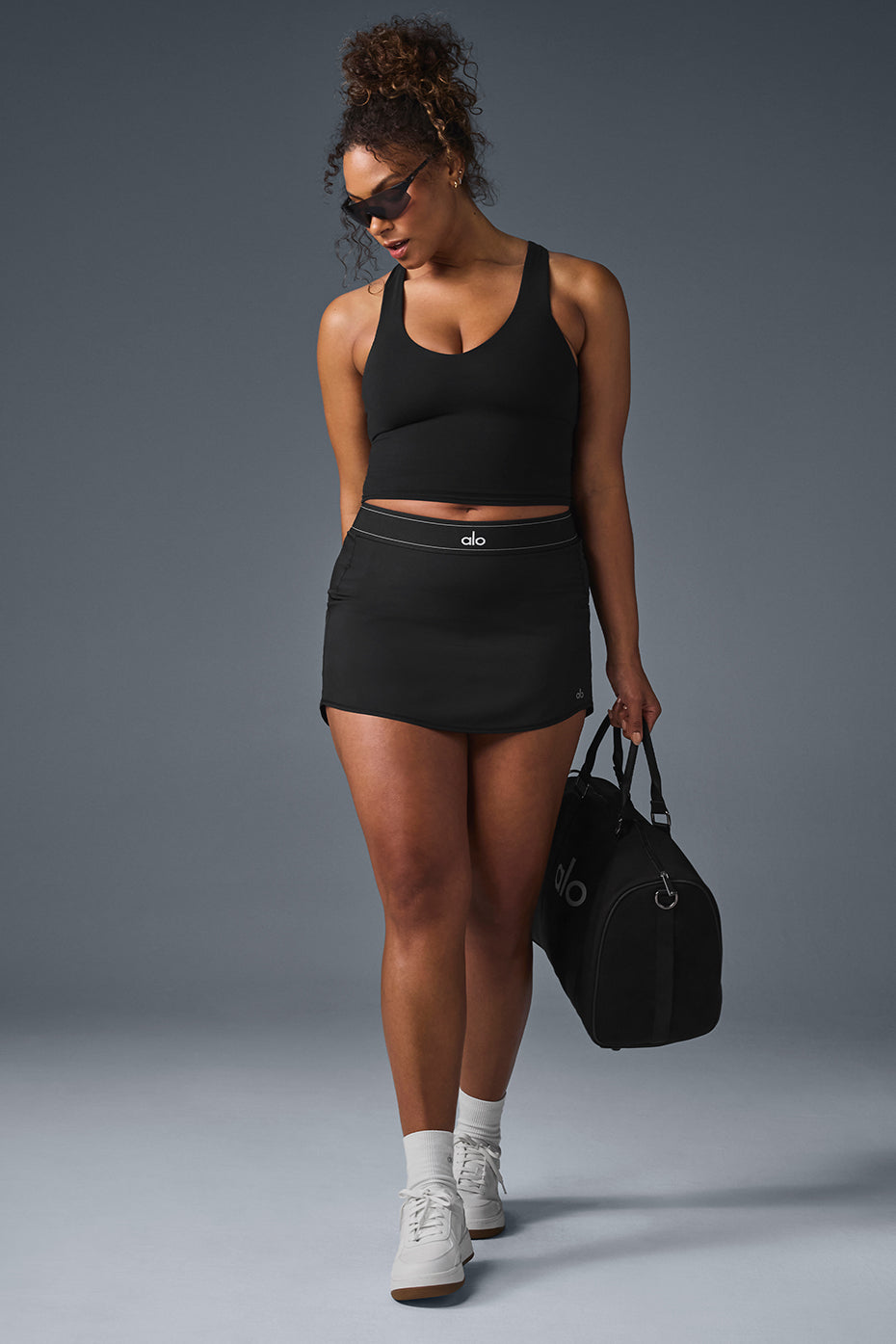 Model wearing the black tank top during a workout session.