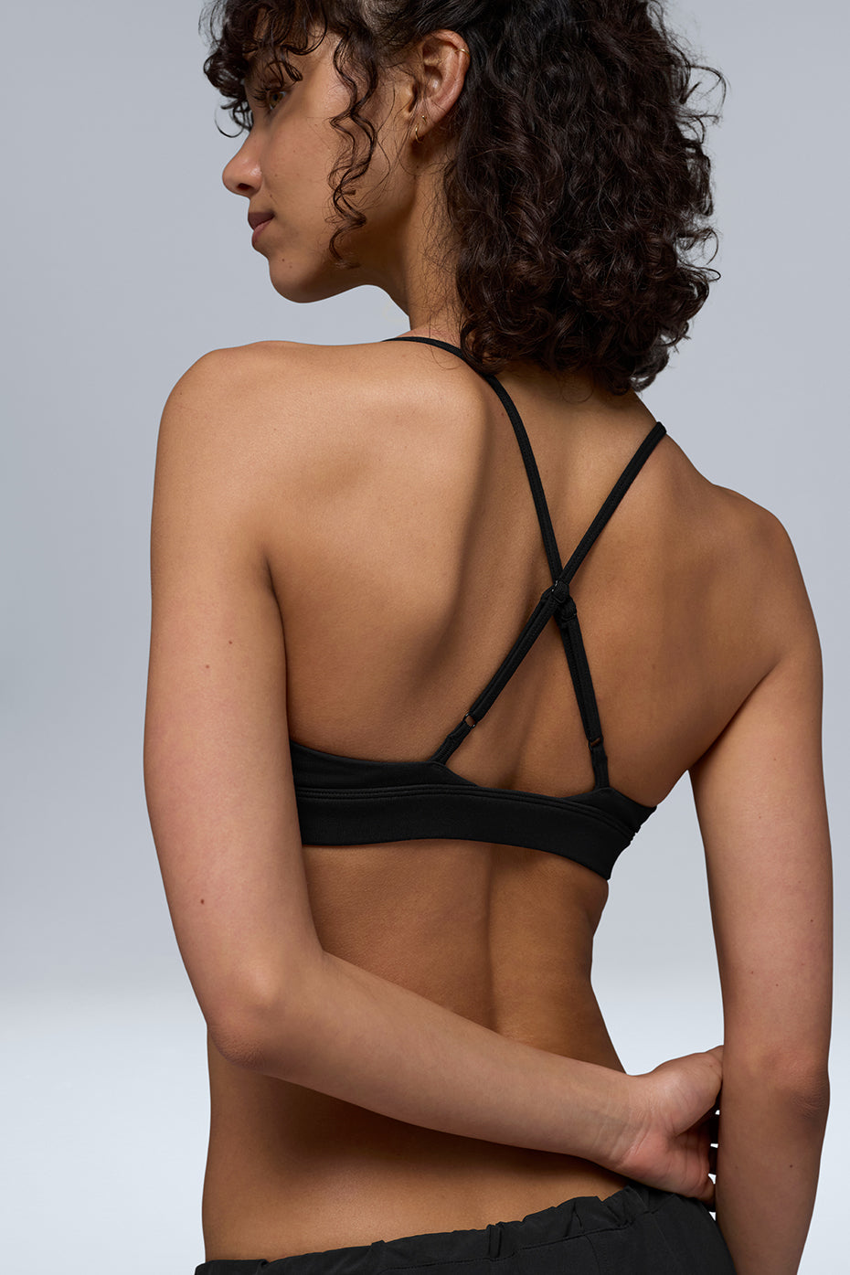 Model wearing the Splendor Bra layered under a crop top for casual wear.