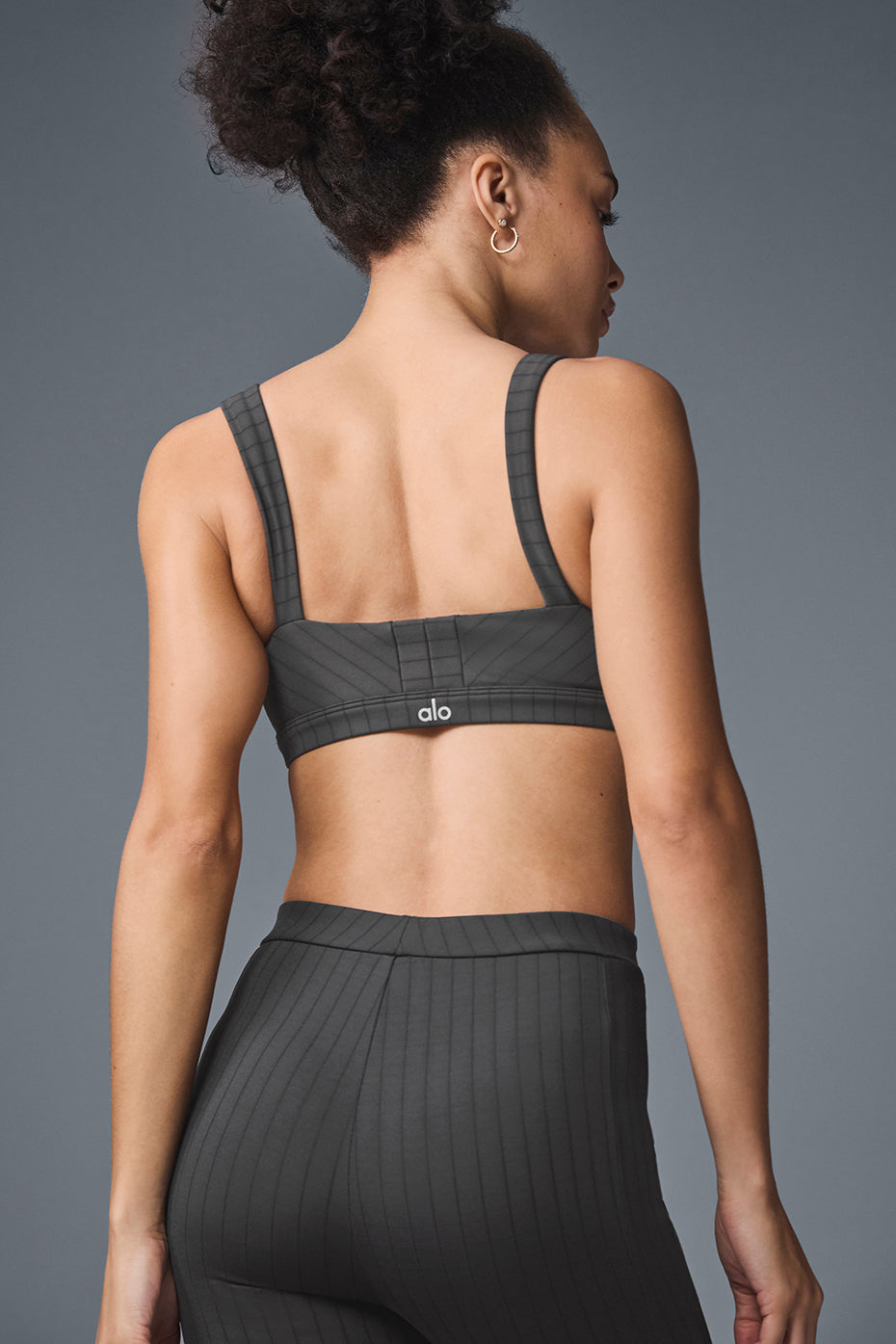 Side angle of the Captivate sports bra, highlighting the tapered straps and notch detail.