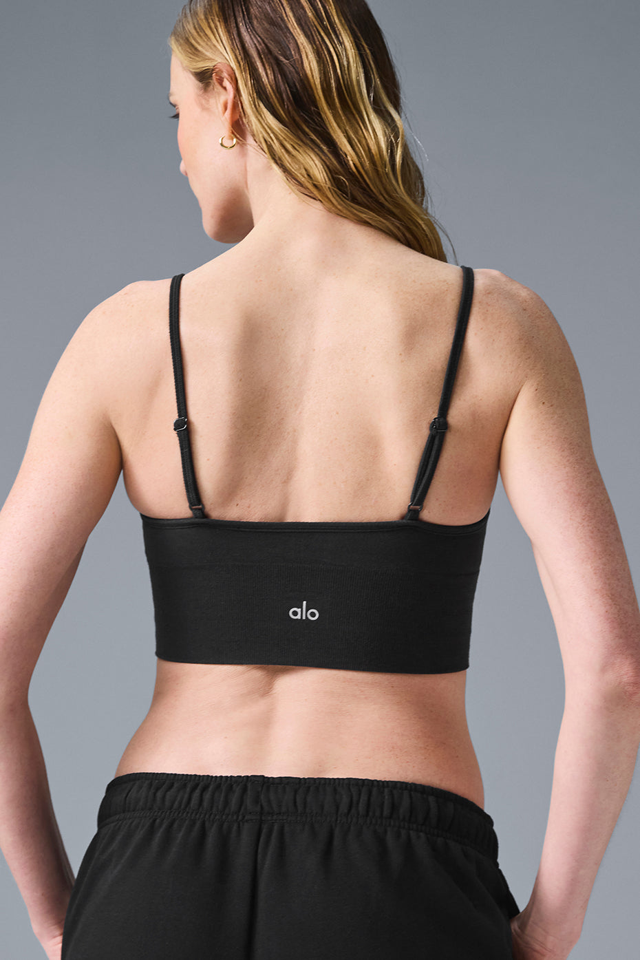 Bralette styled under a loose tank for layered casual outfits.