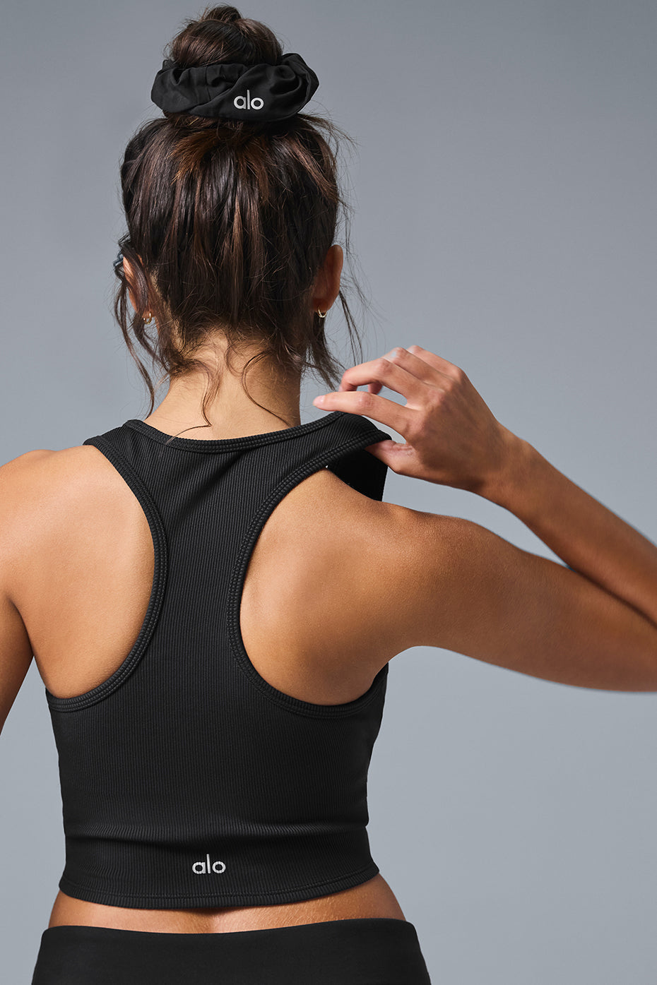 Model wearing the ribbed cropped tank top paired with high-waist leggings for a workout look