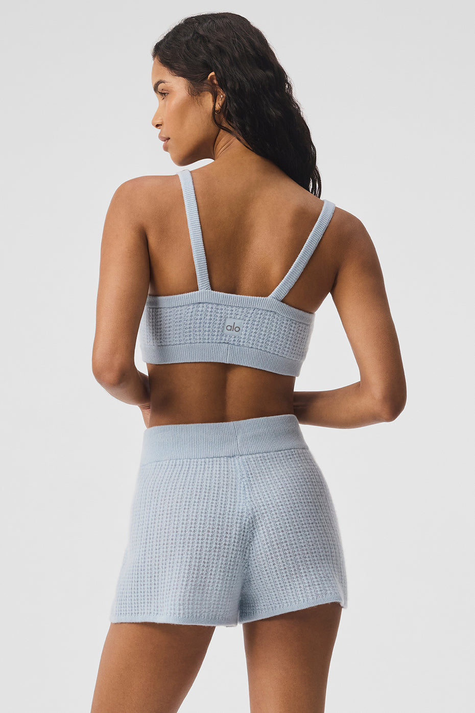 Close-up of the waffle-knit cashmere fabric showing its plush texture and softness.