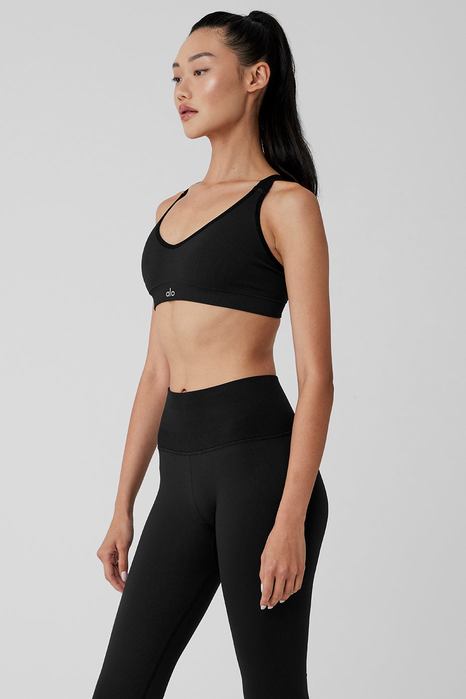 Flat lay of black sports bra with leggings for a coordinated workout set.