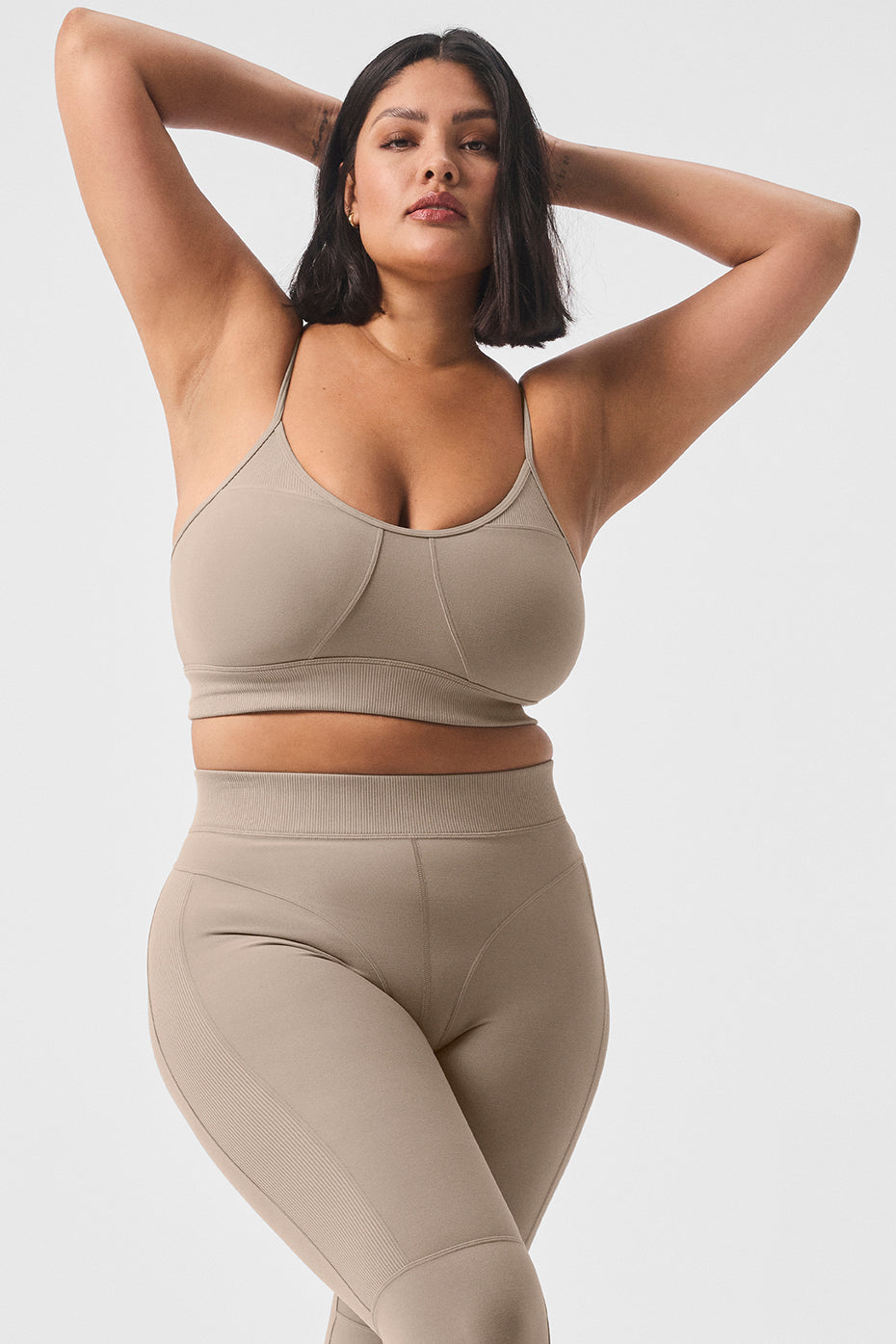 Model wearing the gravel-colored sports bra during a workout, showcasing comfort and support