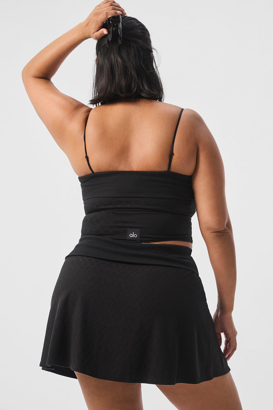 Front view of the Doubles Only sports bra tank top in black, showcasing the ribbed texture.