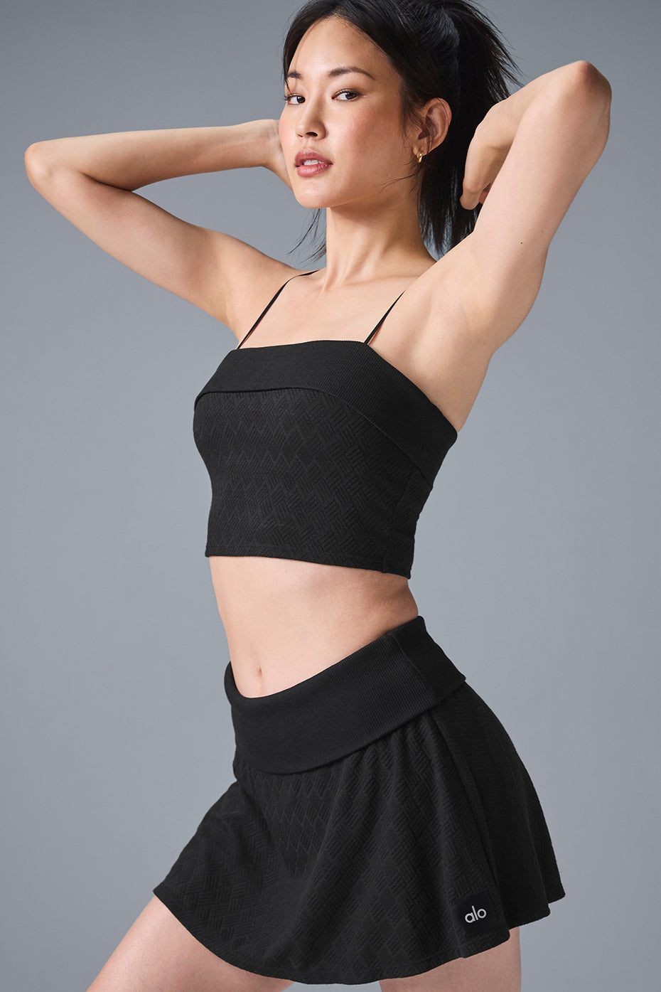 Front view of the Doubles Only sports bra tank top in black, showcasing the ribbed texture.