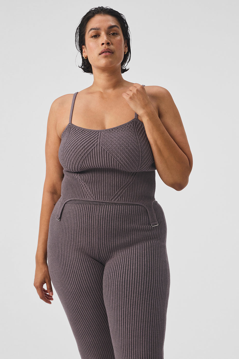 Model wearing the cropped tank top in a casual setting, highlighting its versatile style.