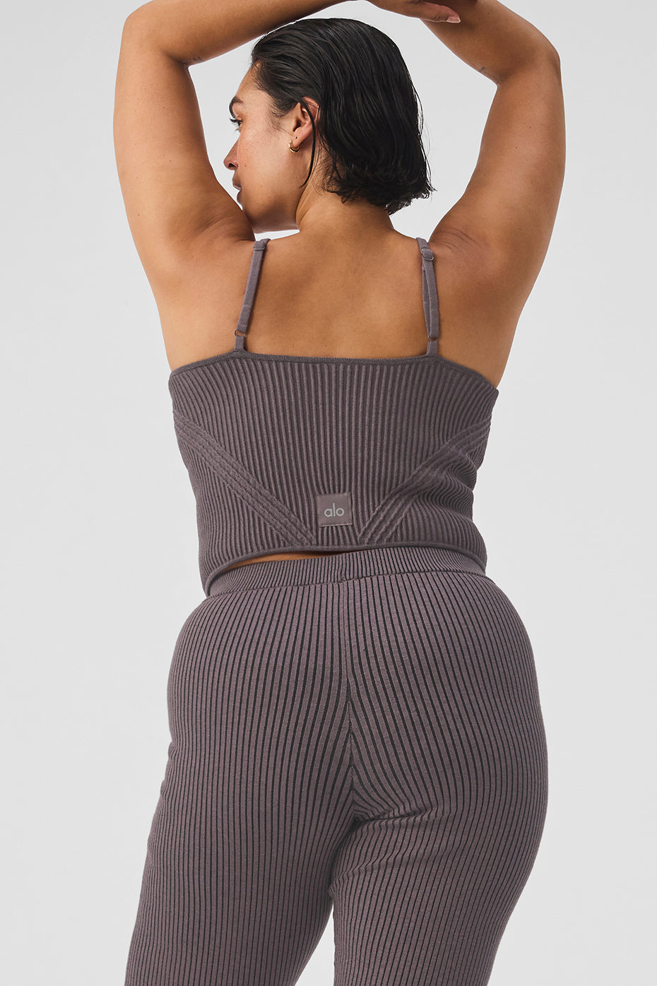 Close-up of the adjustable shoulder straps and garter strap detail of the tank top.