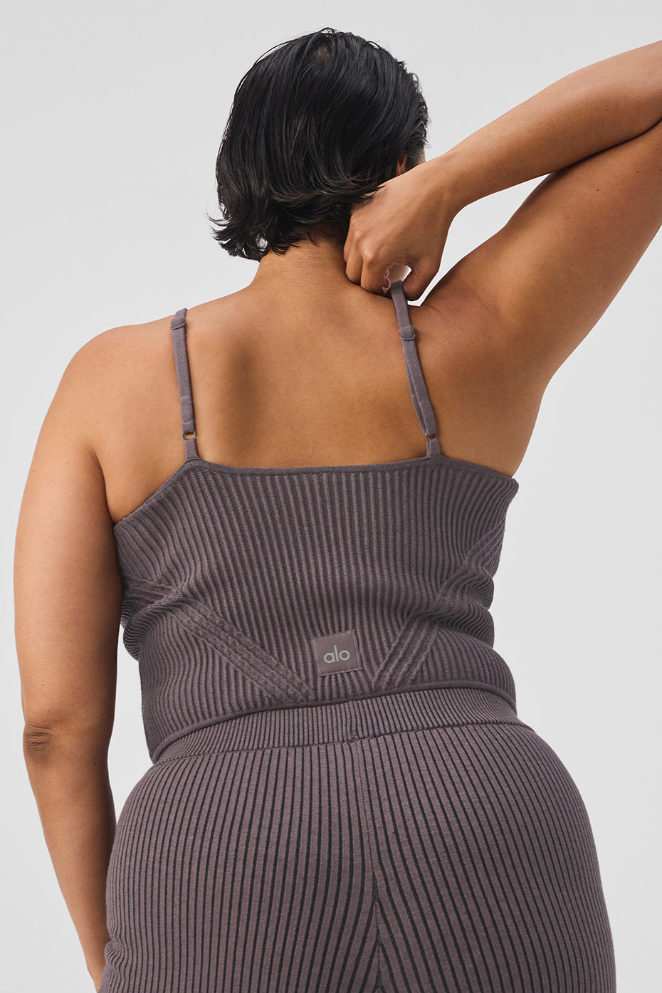 Model wearing the cropped tank top in a casual setting, highlighting its versatile style.