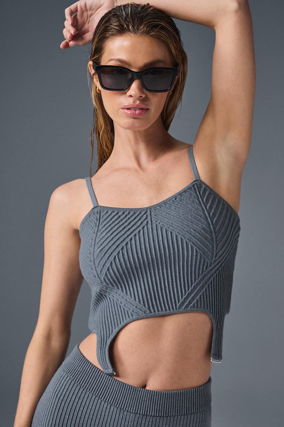 Front view of steel grey ribbed tank top with garter detail, styled with high-waisted jeans.