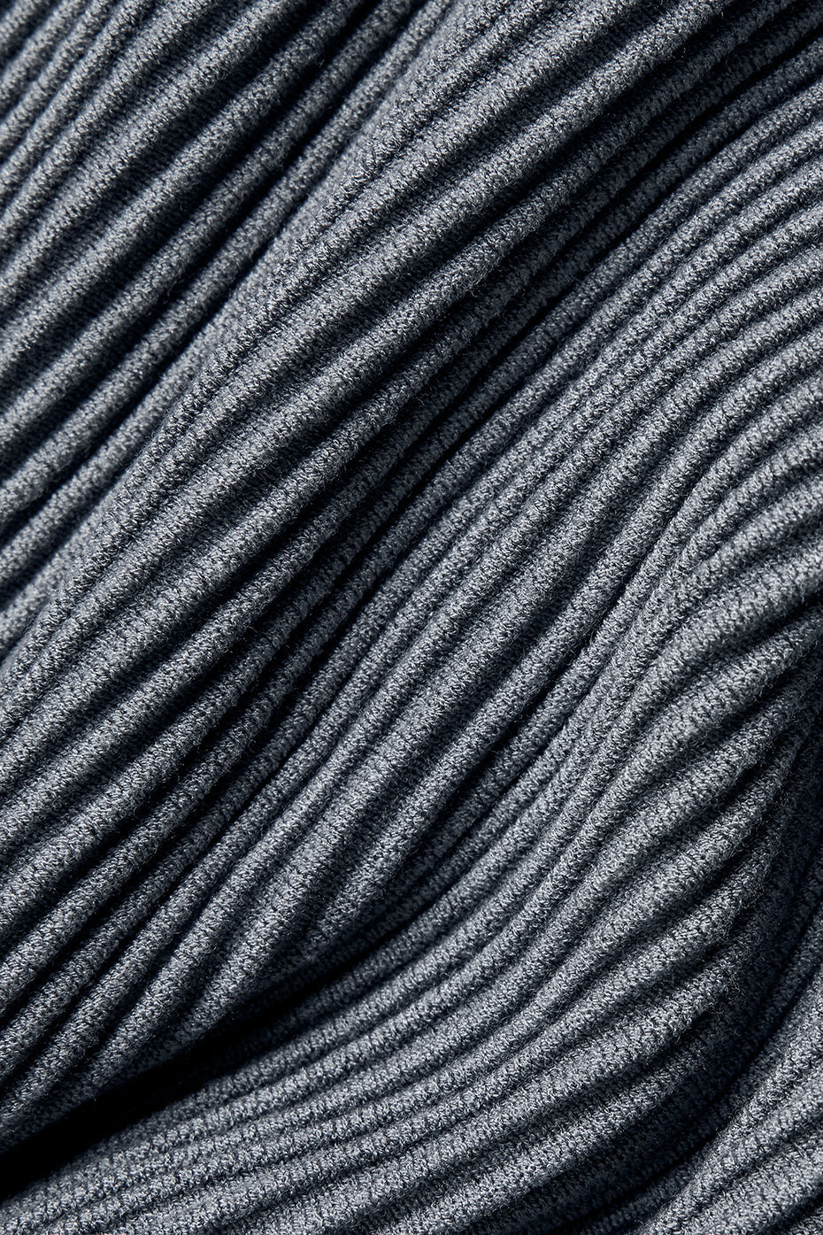 Side angle of cropped denim tank showing adjustable straps and textured knit fabric.