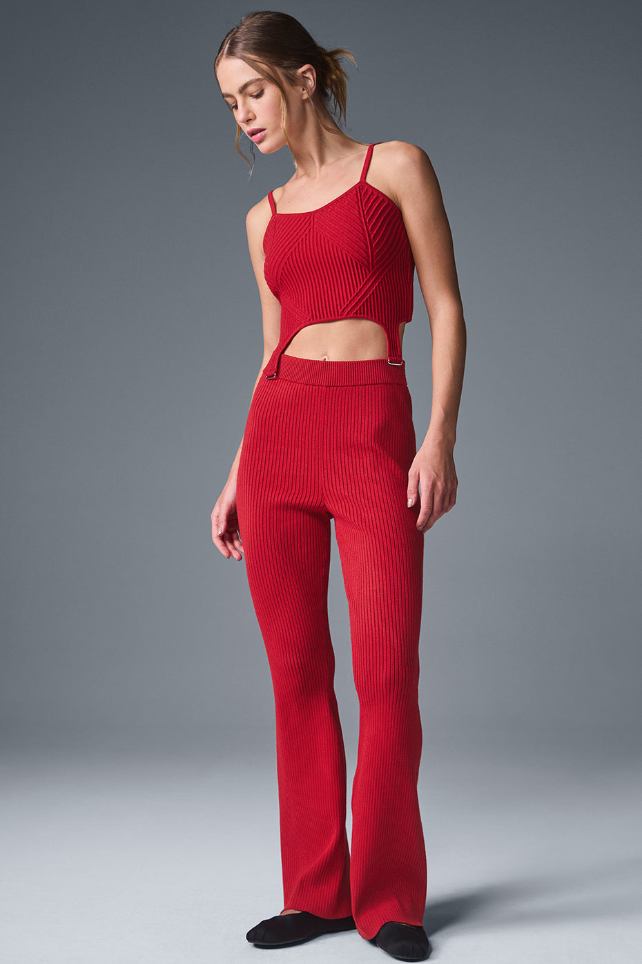 Cropped denim tank top laid flat, showcasing ribbed texture and bold red color.