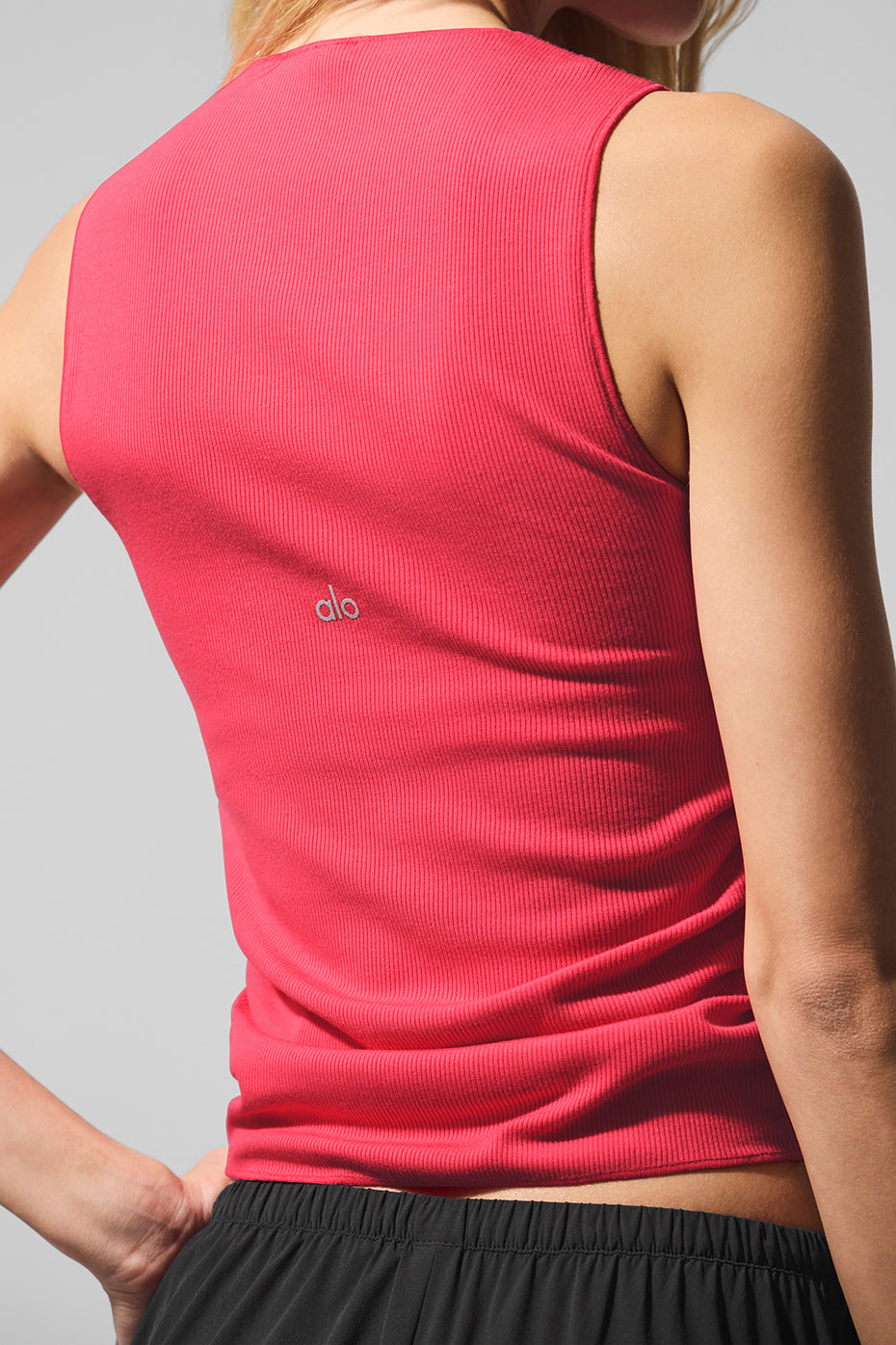 Back view of the ribbed activewear crop top, highlighting the built-in shelf bra.