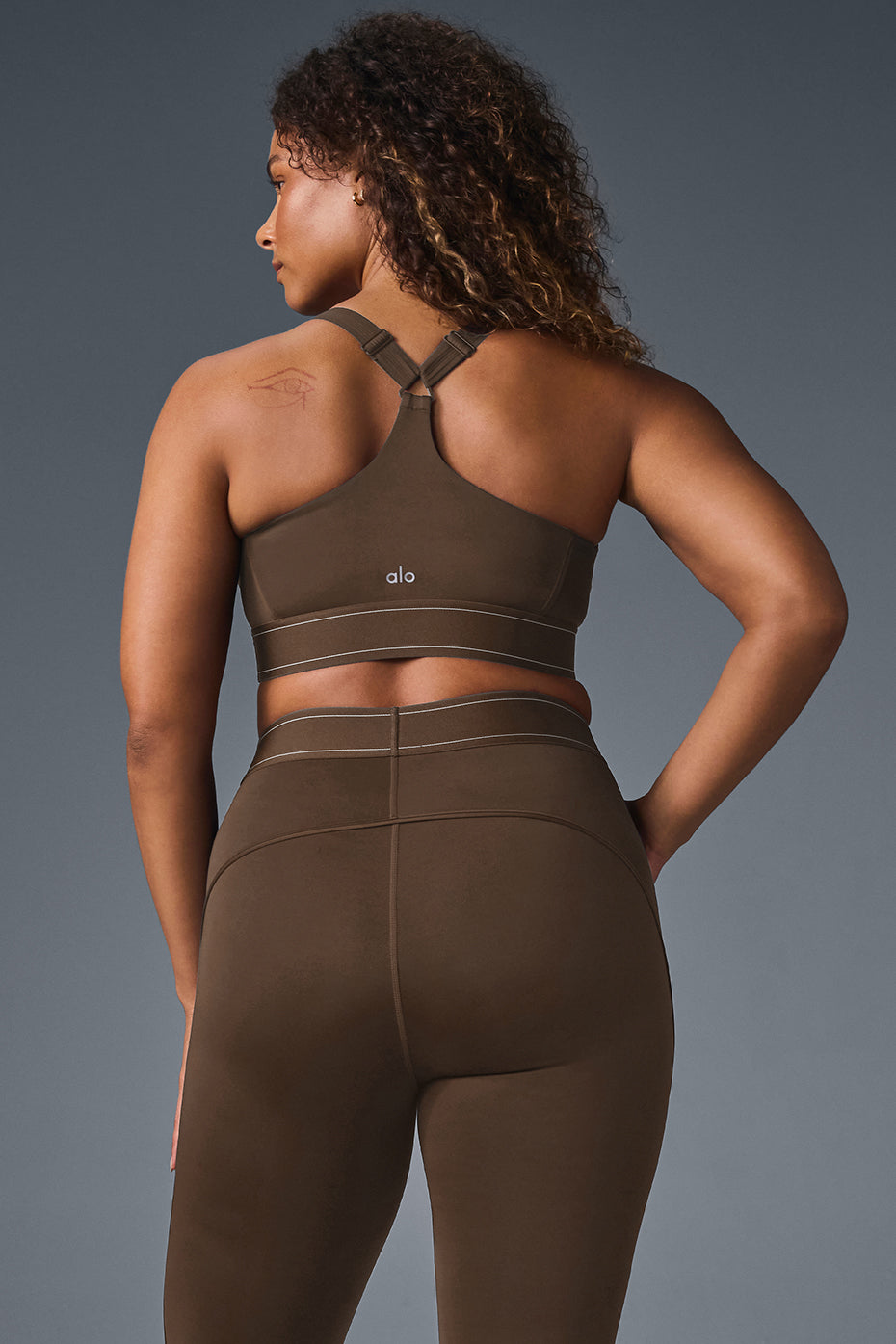Layered streetwear styling of sports bra for city movement