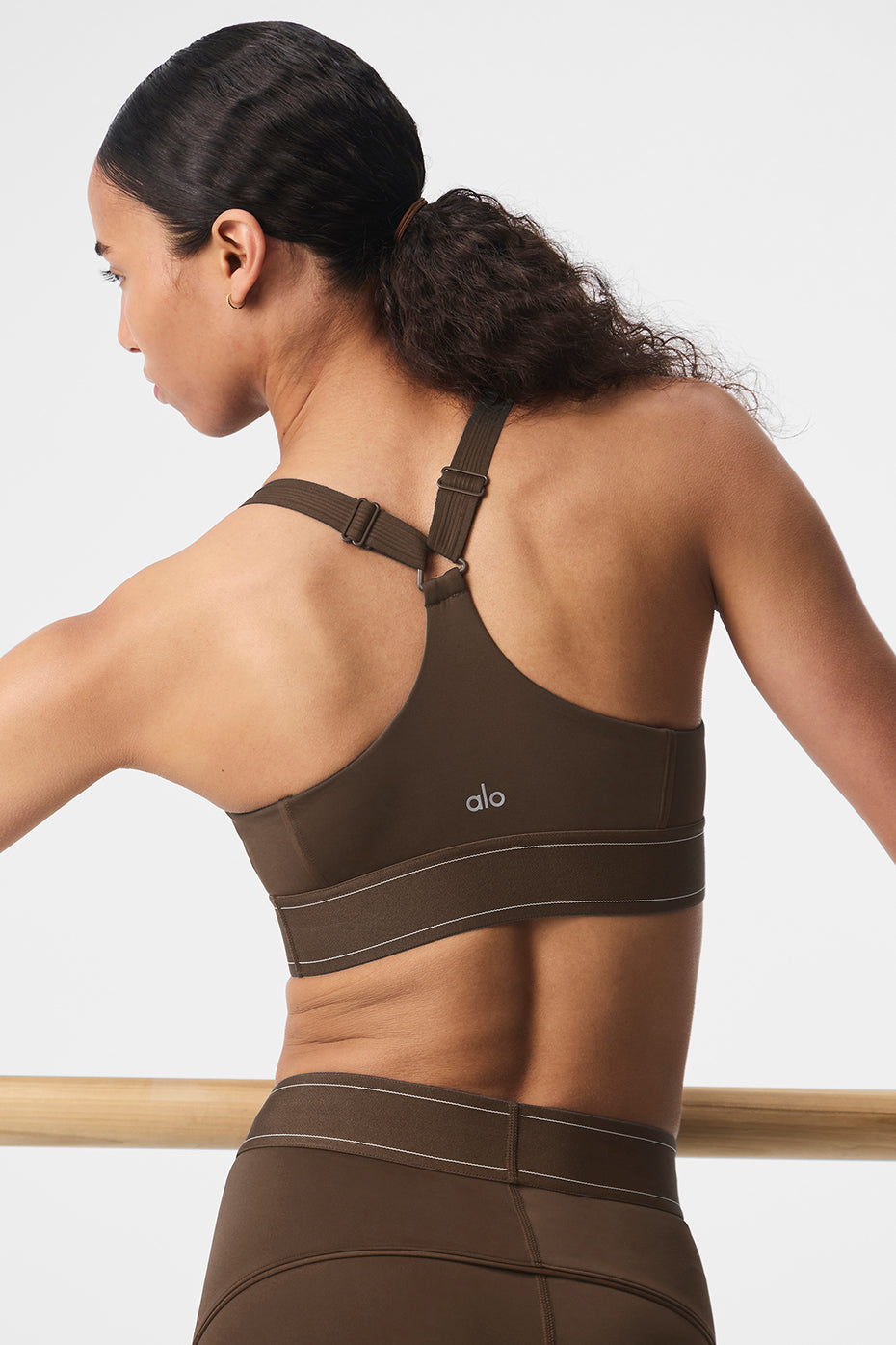Back view highlighting adjustable straps and sleek espresso tone