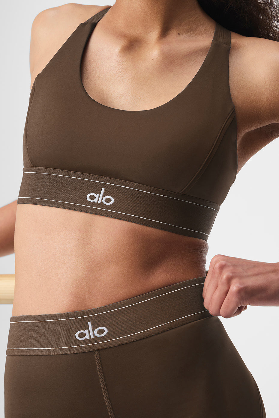 Layered streetwear styling of sports bra for city movement