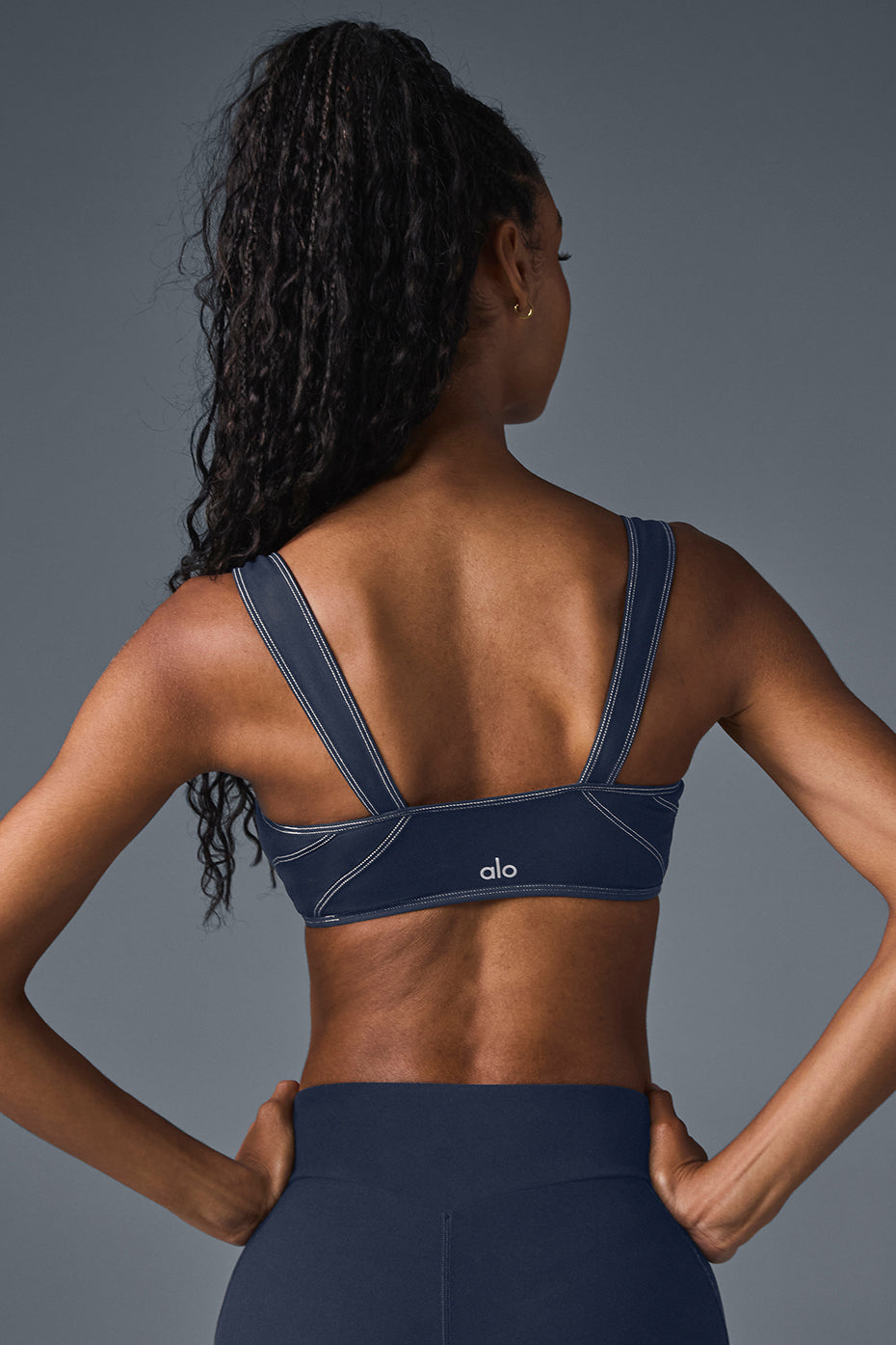 Side view of Alosoft Sunray bra paired with high-waist leggings