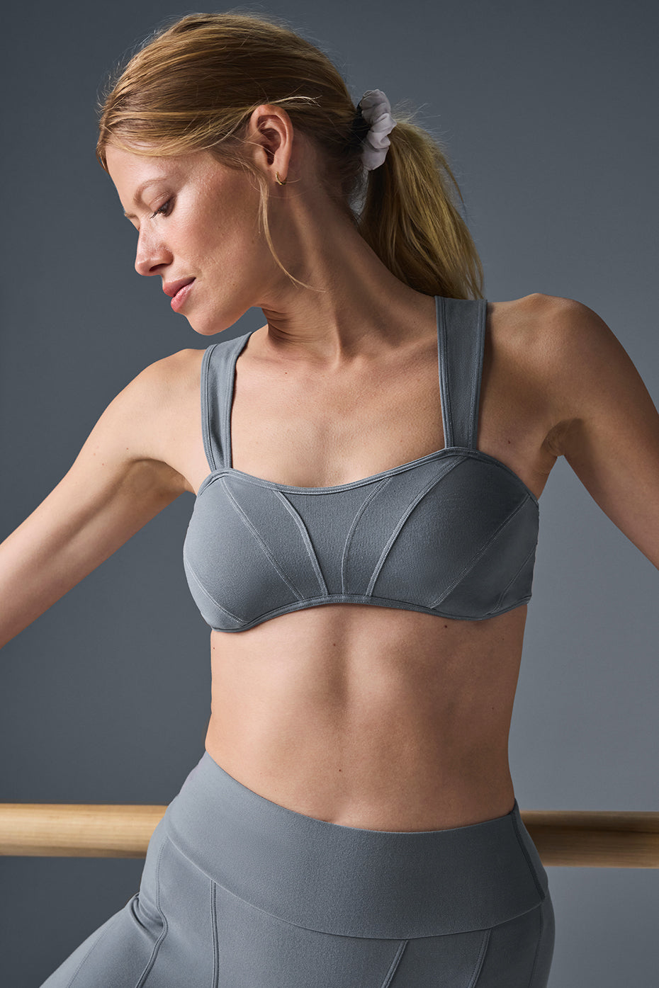 Front view of grey sports bra sports style with contrast seams in NYC studio