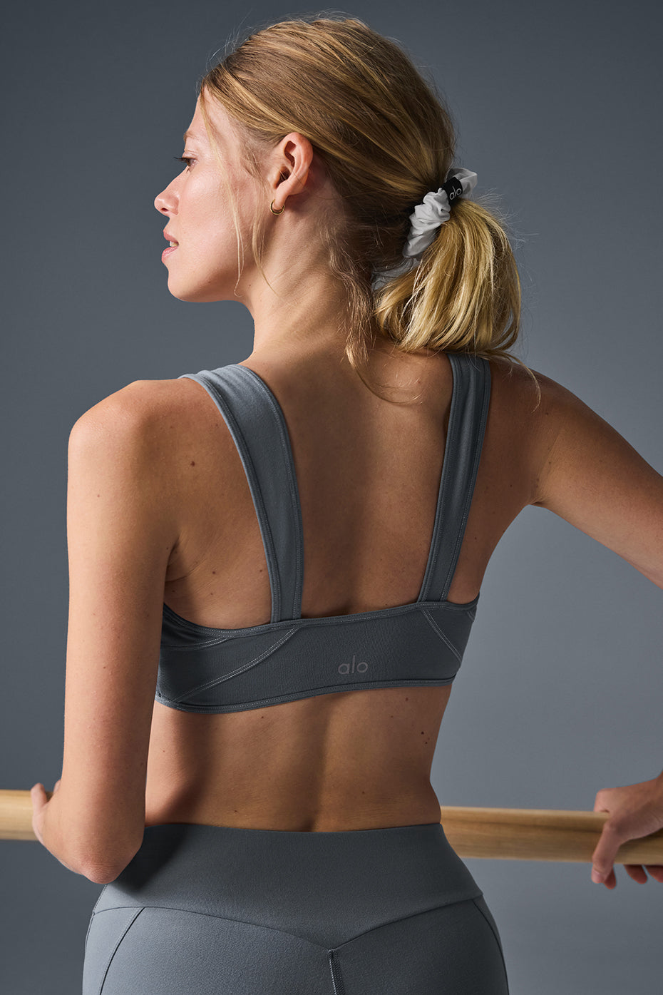 Side profile showing yoga bra fit and scooped neckline during light movement