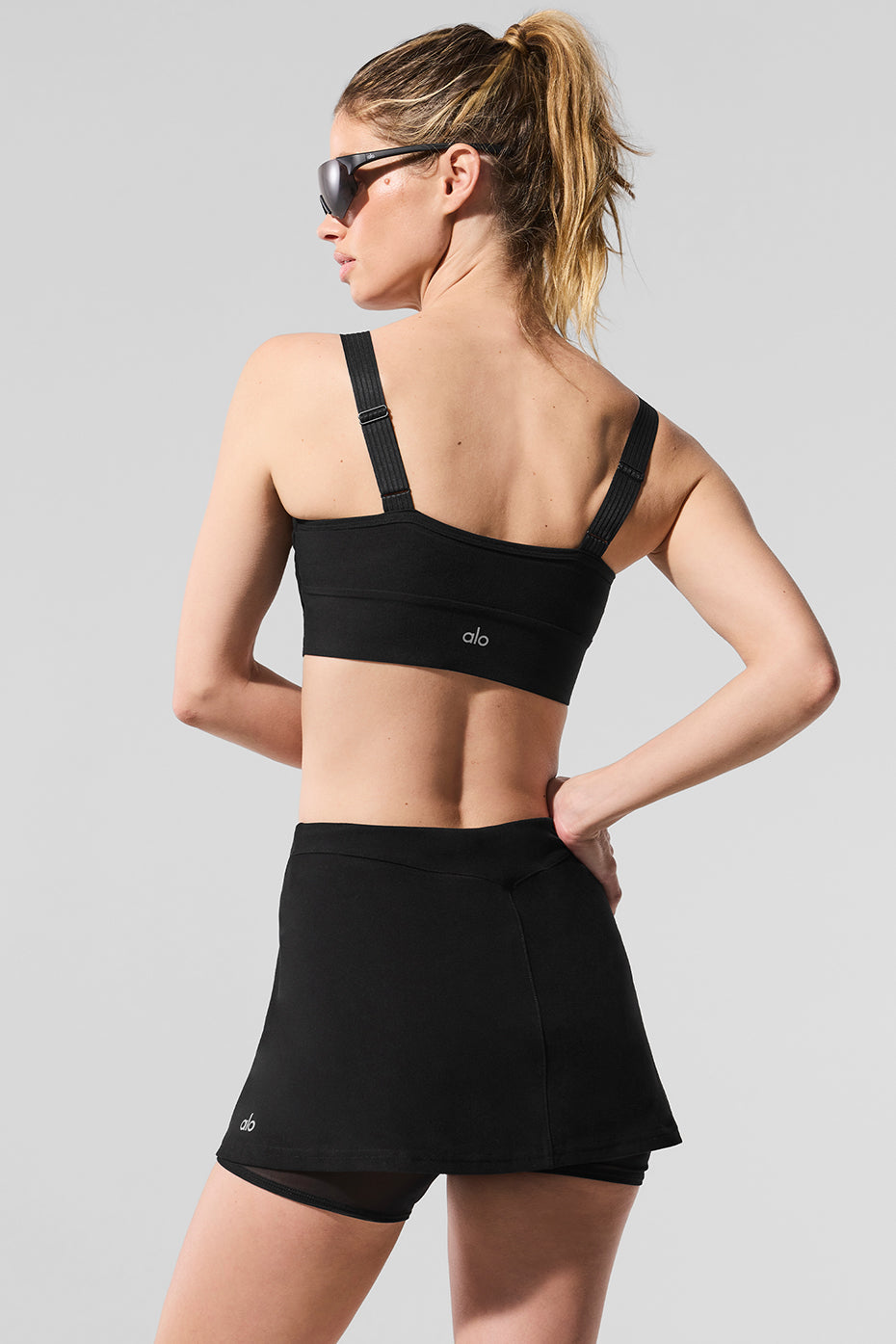 Close-up of the fabric and design details of the black sports bra