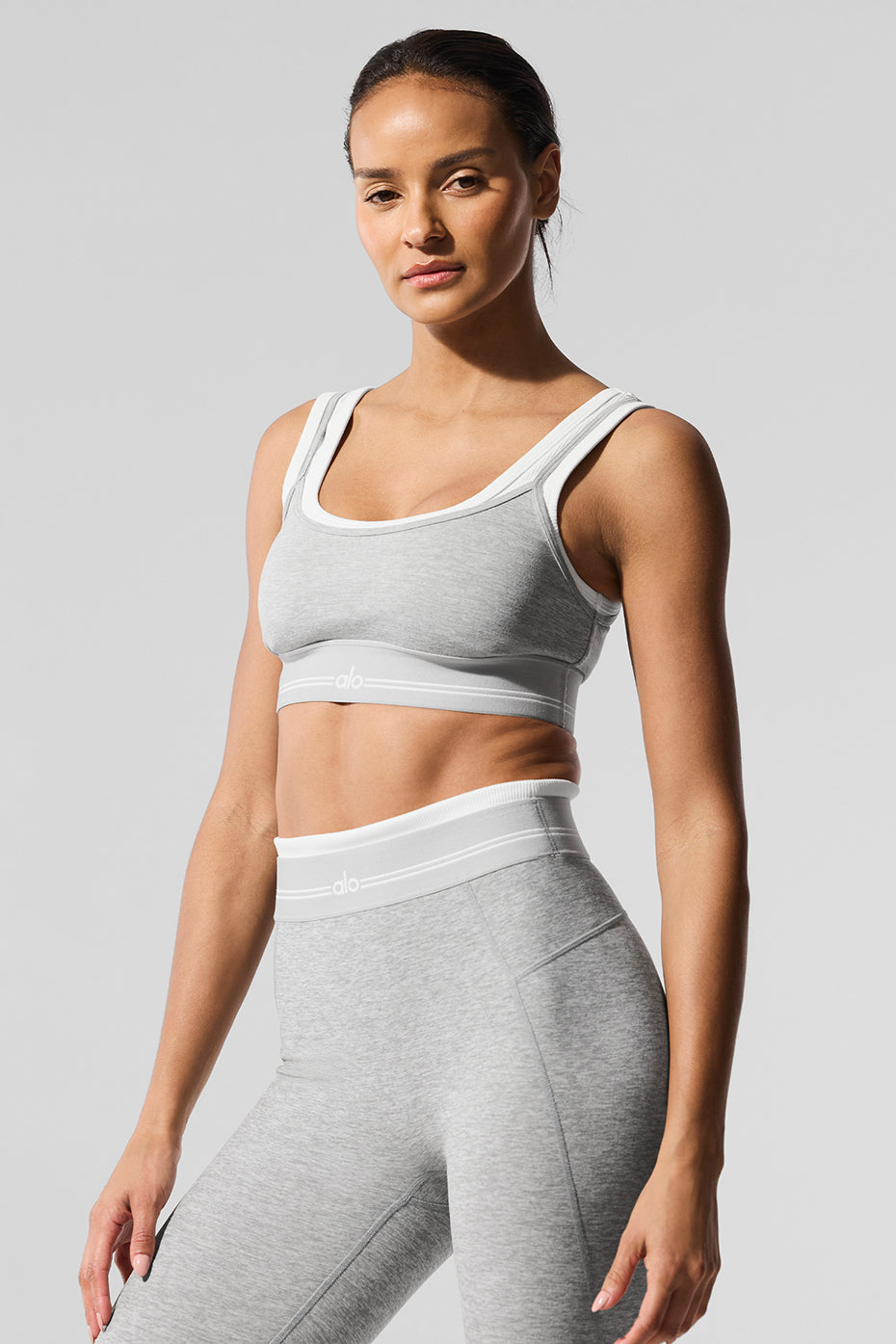 Front view of the Alosoft Better Together sports bra in Heather Grey and White with logo band