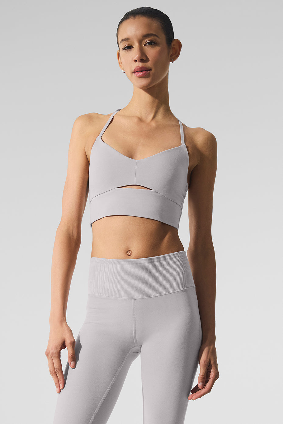 Lifestyle shot of woman wearing yoga bra during morning stretch