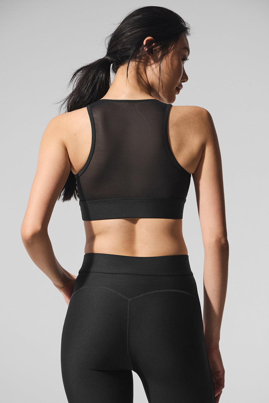 Model wearing the Airlift Mesh Just Right Sports Bra during a workout, demonstrating its flexibility and style.