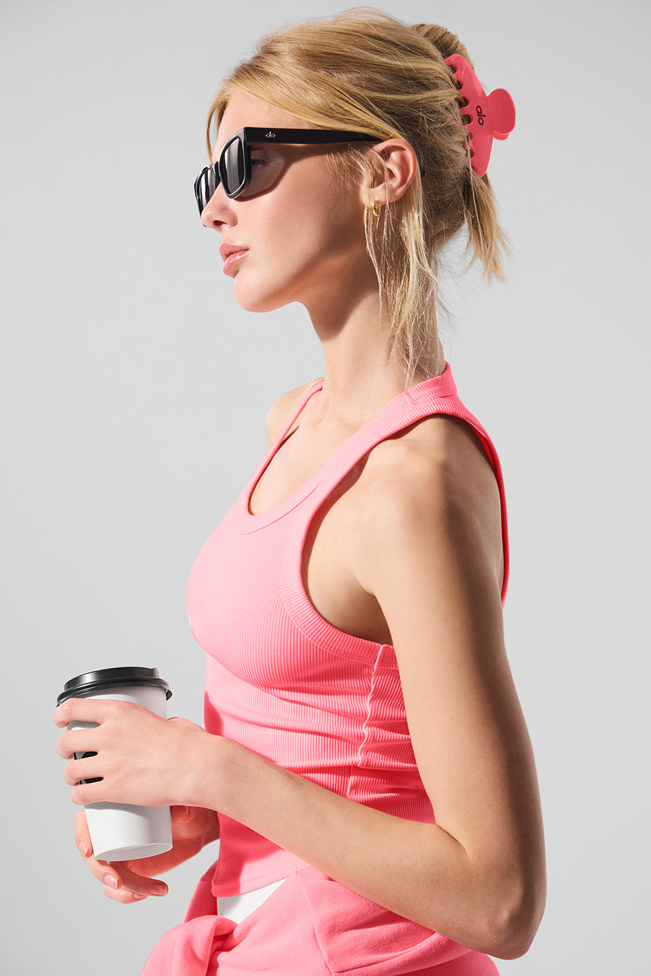 Side view of claw clip securing long hair during a workout, inspired by 90s fashion