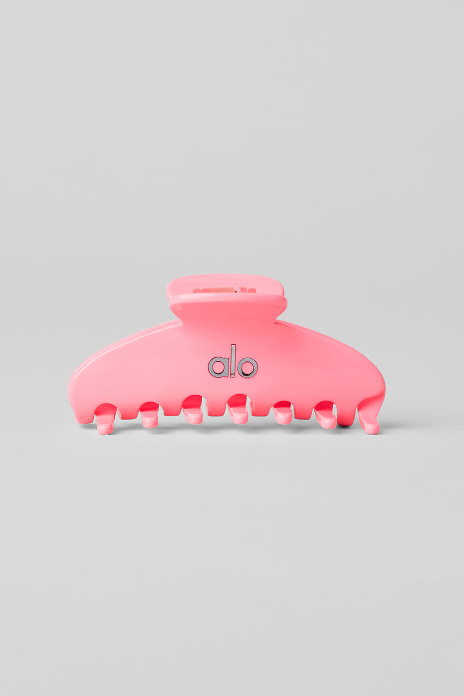 Close-up of neon bubblegum claw clip on textured hair, perfect for wedding hair accessories