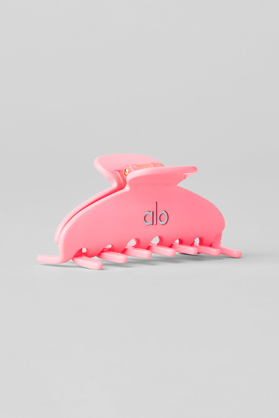 Close-up of neon bubblegum claw clip on textured hair, perfect for wedding hair accessories