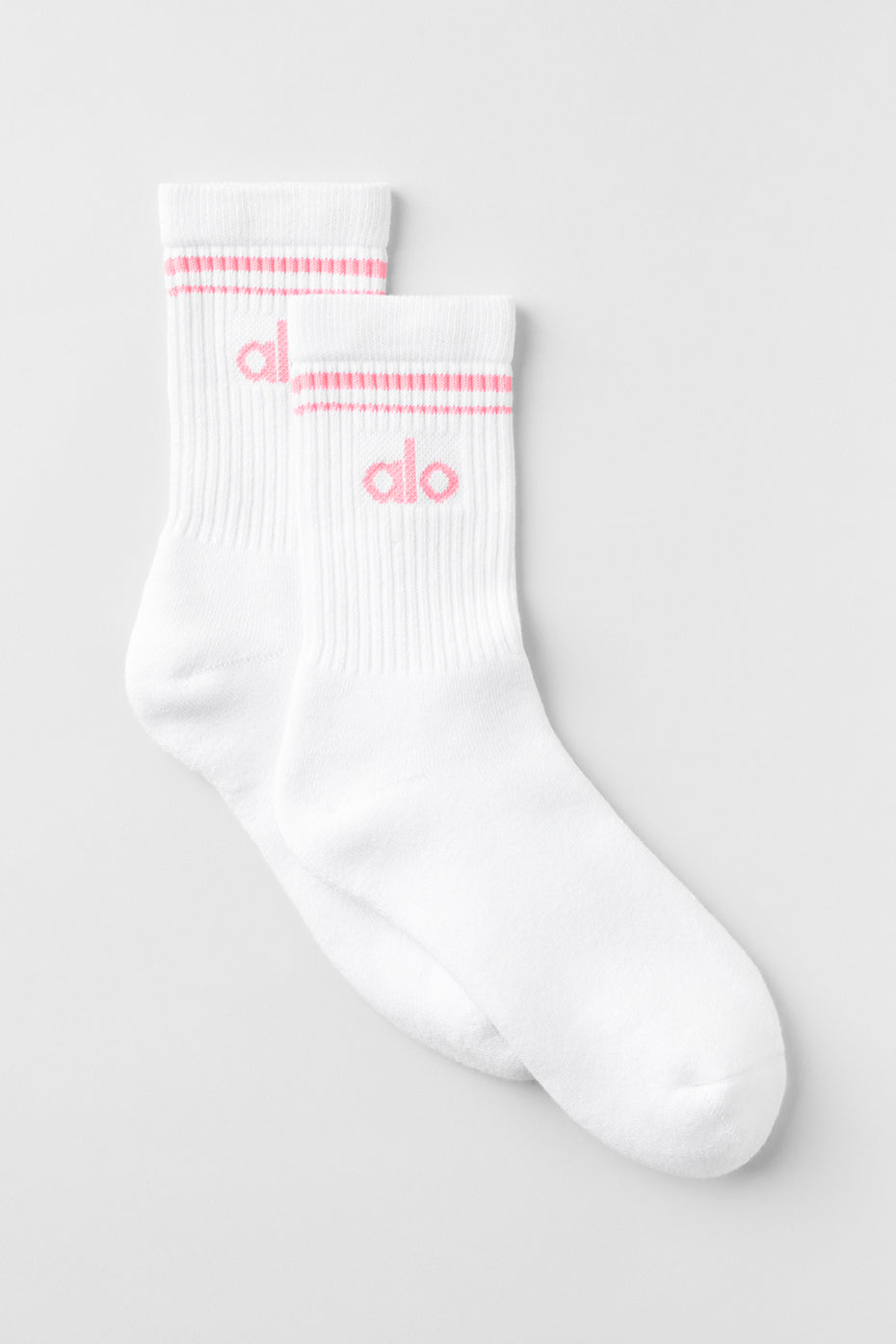 Close-up of retro crew socks in white and neon bubblegum, showcasing the soft fabric.
